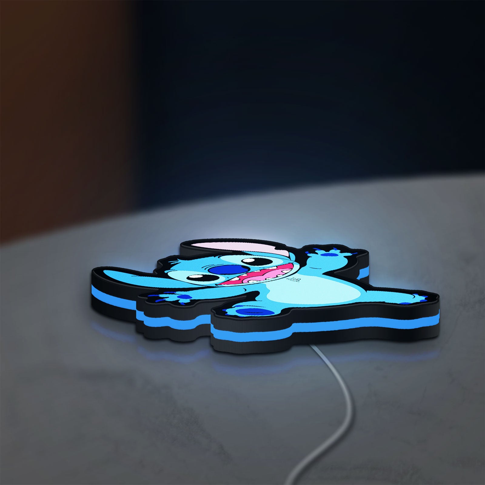 Stitch Happy LED lightbox lying flat on a desk with blue glow