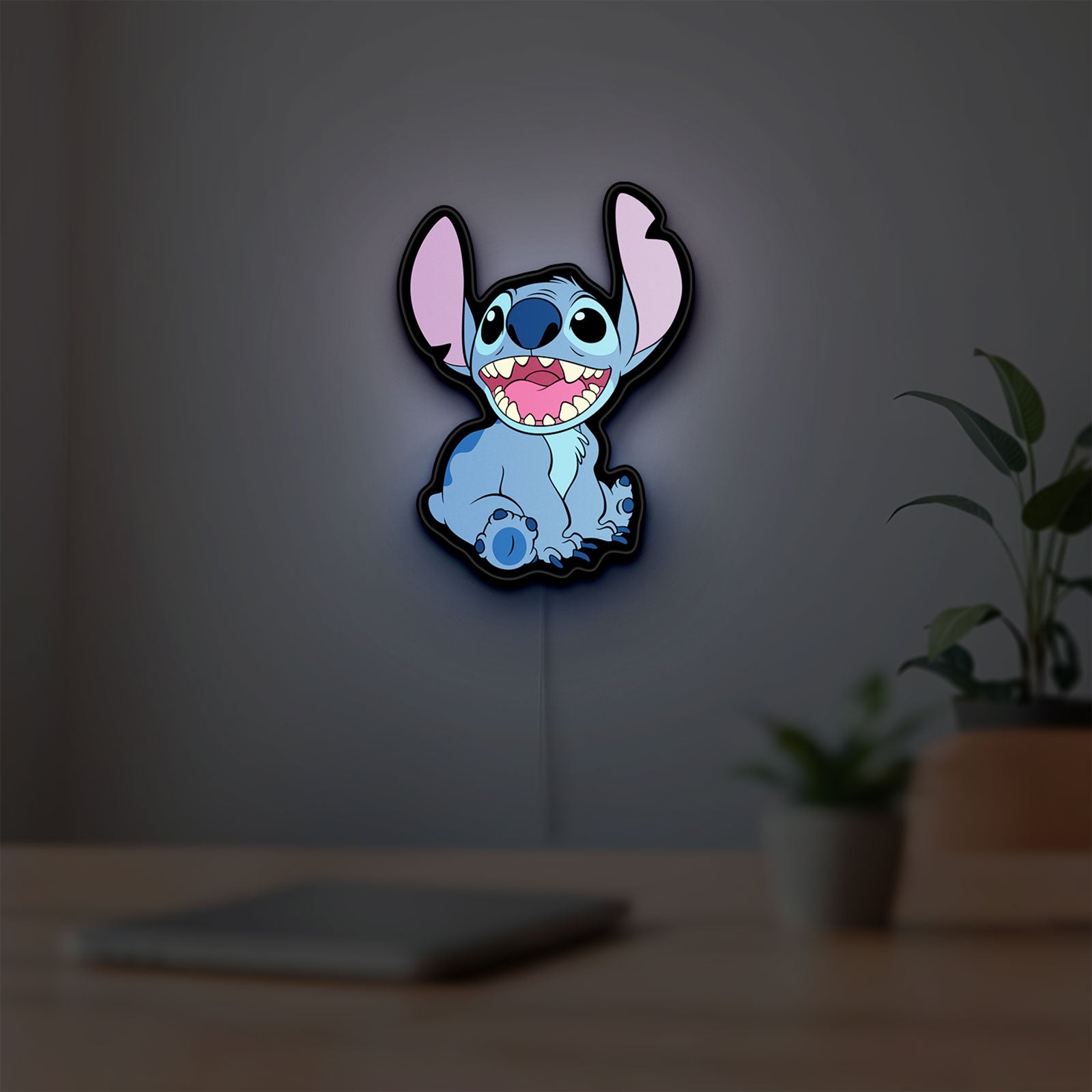 Lilo & Stitch LED lightbox hanging on a room wall with soft blue light