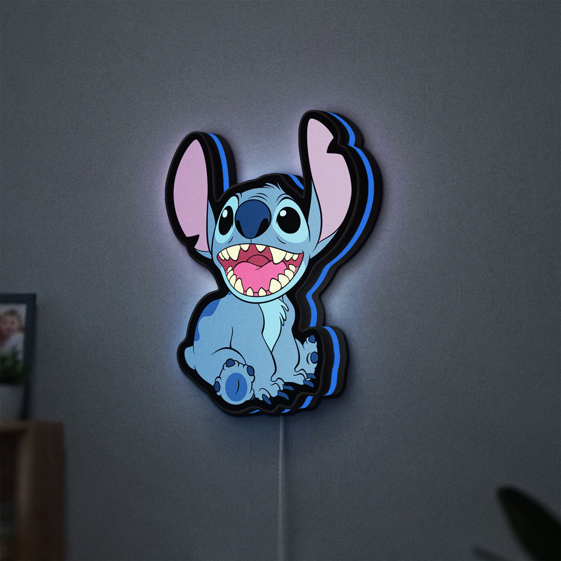 Lilo & Stitch LED lightbox hanging on a wall with blue glow