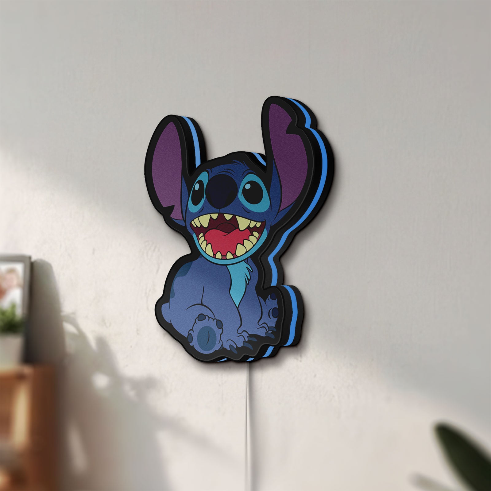 Unlit Lilo & Stitch LED lightbox mounted on a wall in daylight