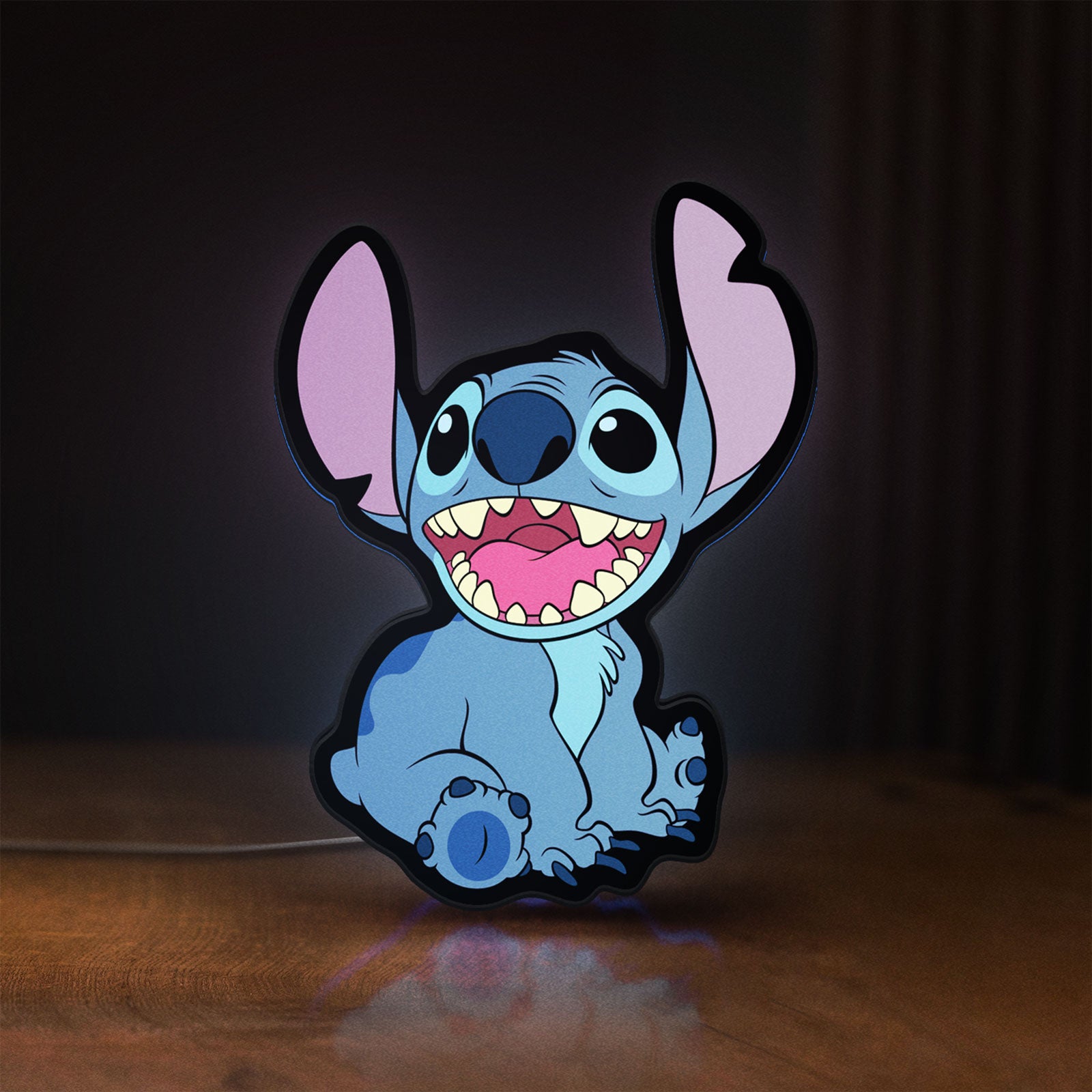 Front view of Lilo & Stitch LED lightbox sign glowing on a wooden desk