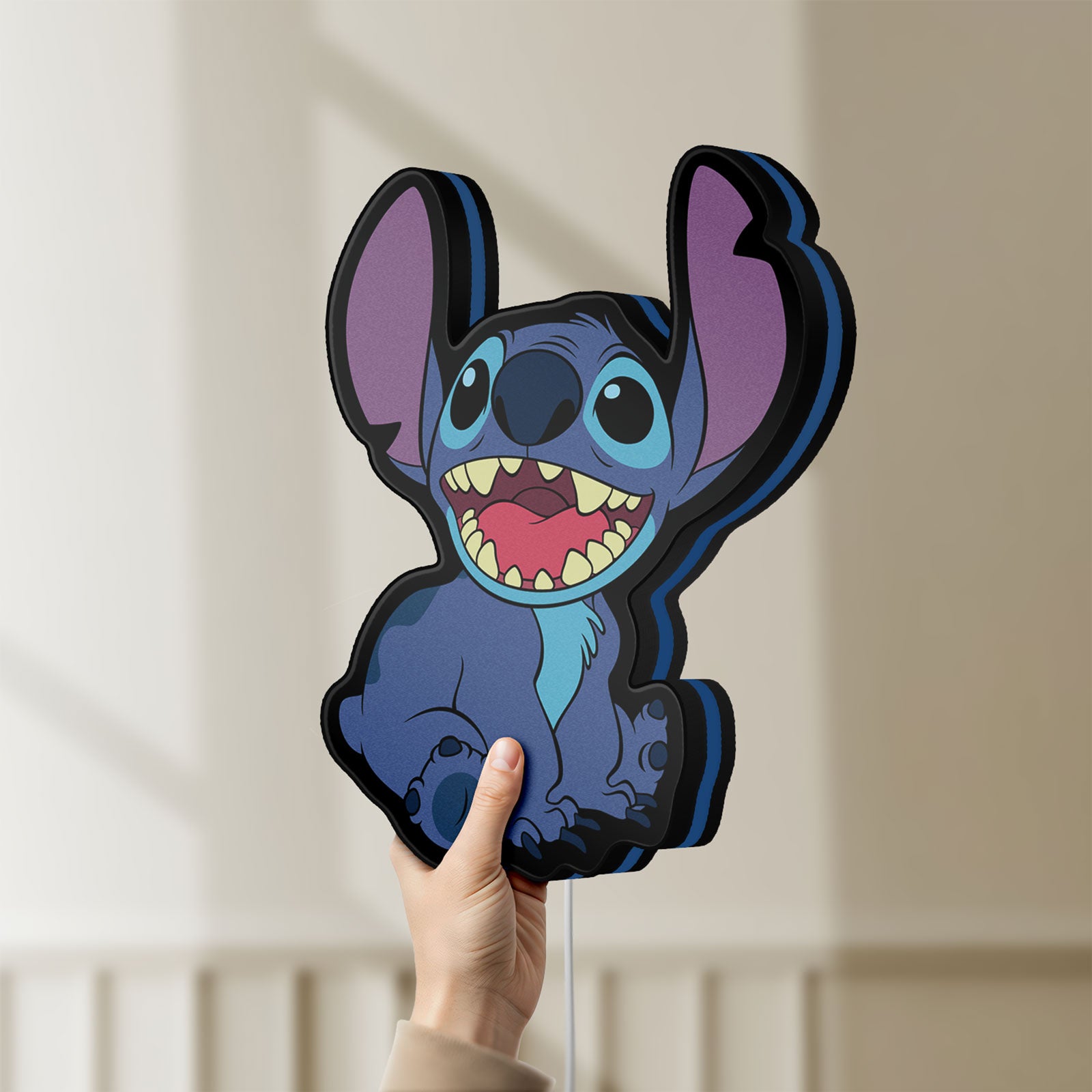 Unlit Lilo & Stitch LED lightbox held by hand to show size and details