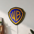 Unlit Warner Bros Shield LED lightbox mounted on a wall in daylight