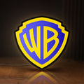 Front view of Warner Bros Shield LED lightbox sign glowing on a wooden desk