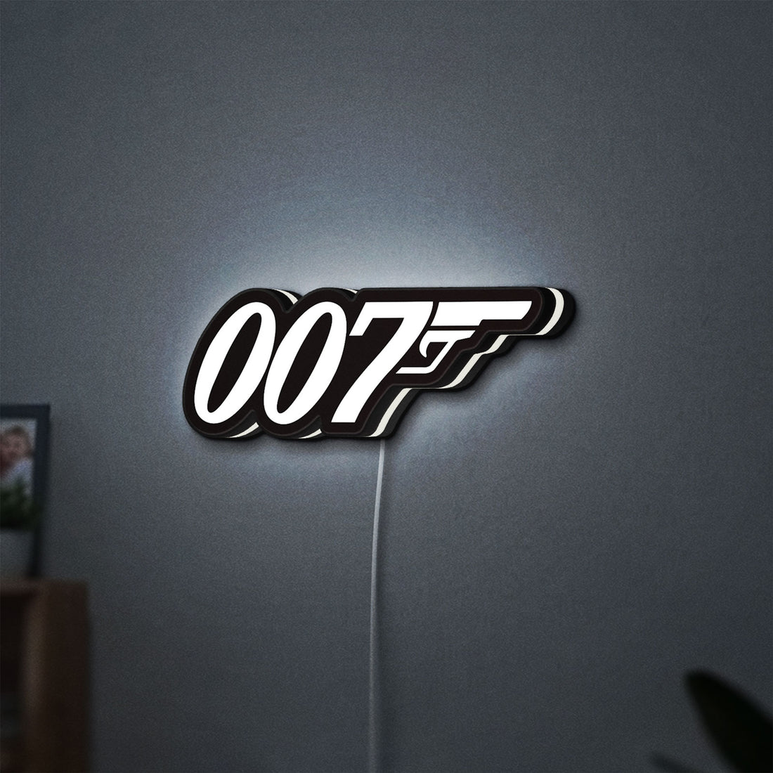 James Bond 007 LED lightbox hanging on a wall with white glow