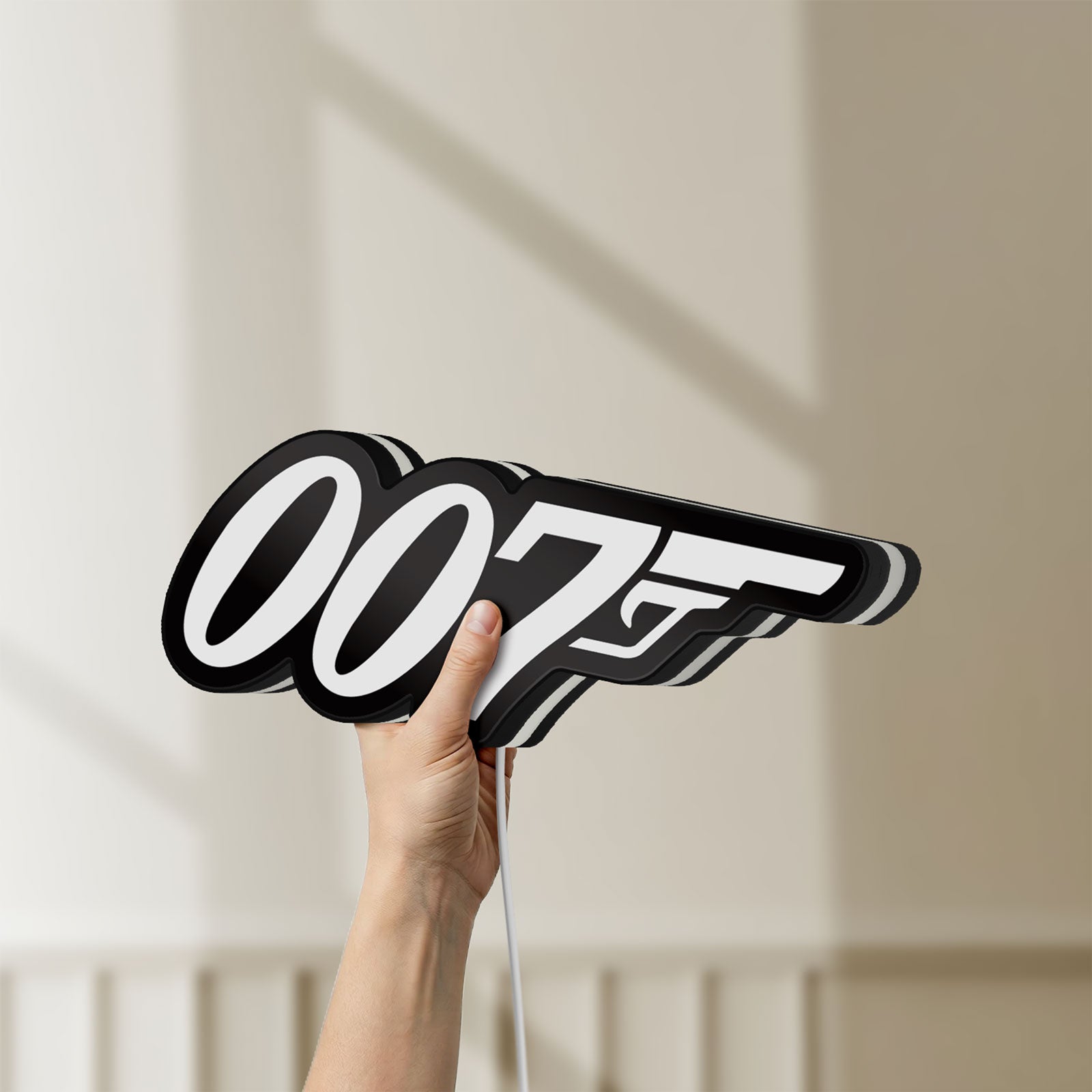 Unlit James Bond 007 LED lightbox held by hand to show size and details