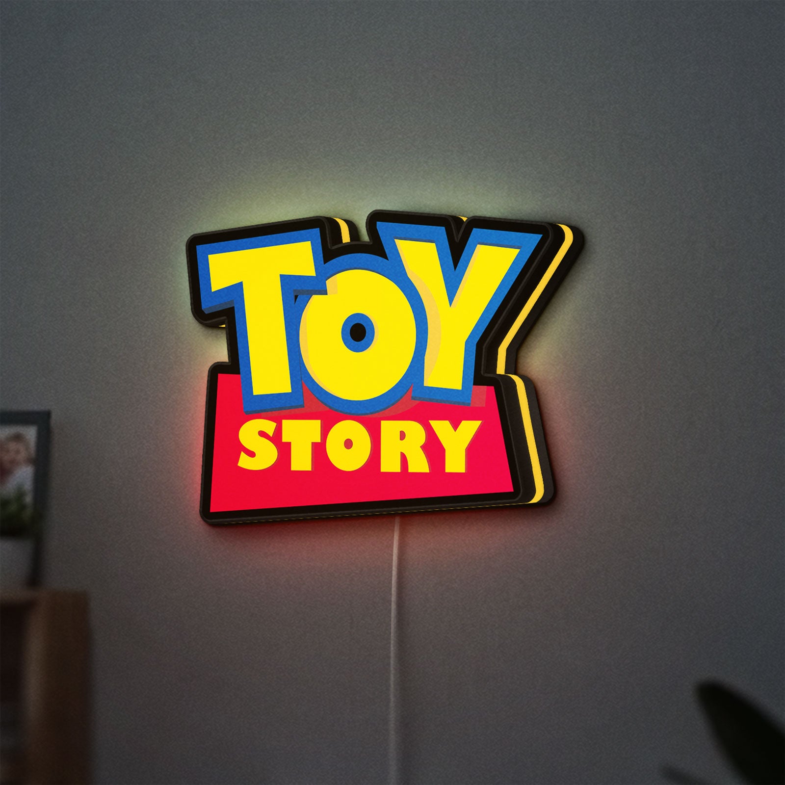 Toy Story LED lightbox hanging on a wall with yellow glow