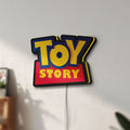 Unlit Toy Story LED lightbox mounted on a wall in daylight
