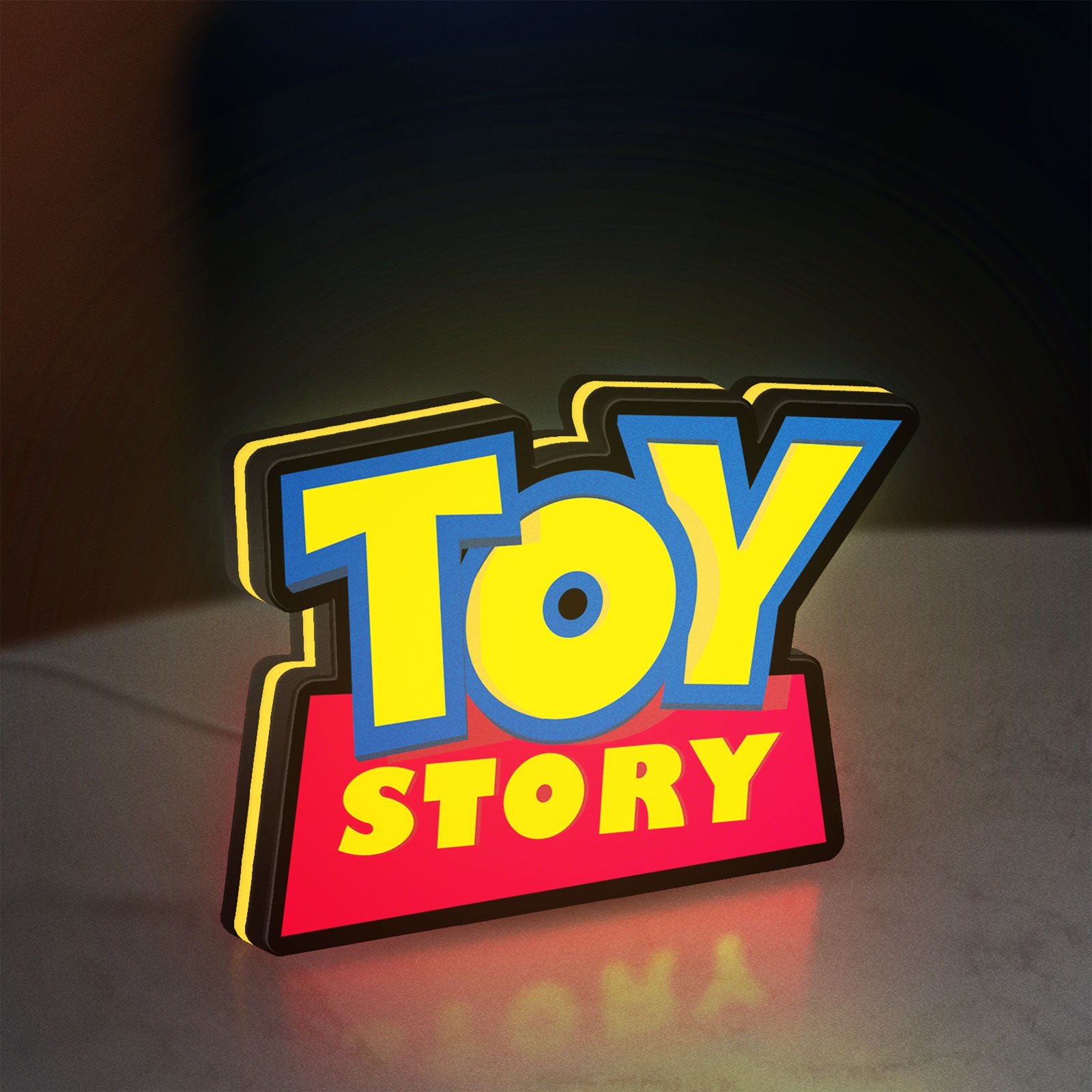 Toy Story LED lightbox standing on a desk from an angled side view with yellow glow