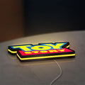 Toy Story LED lightbox lying flat on a desk with yellow glow