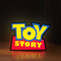 Front view of Toy Story LED lightbox sign glowing on a wooden desk