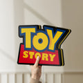 Unlit Toy Story LED lightbox held by hand to show size and details