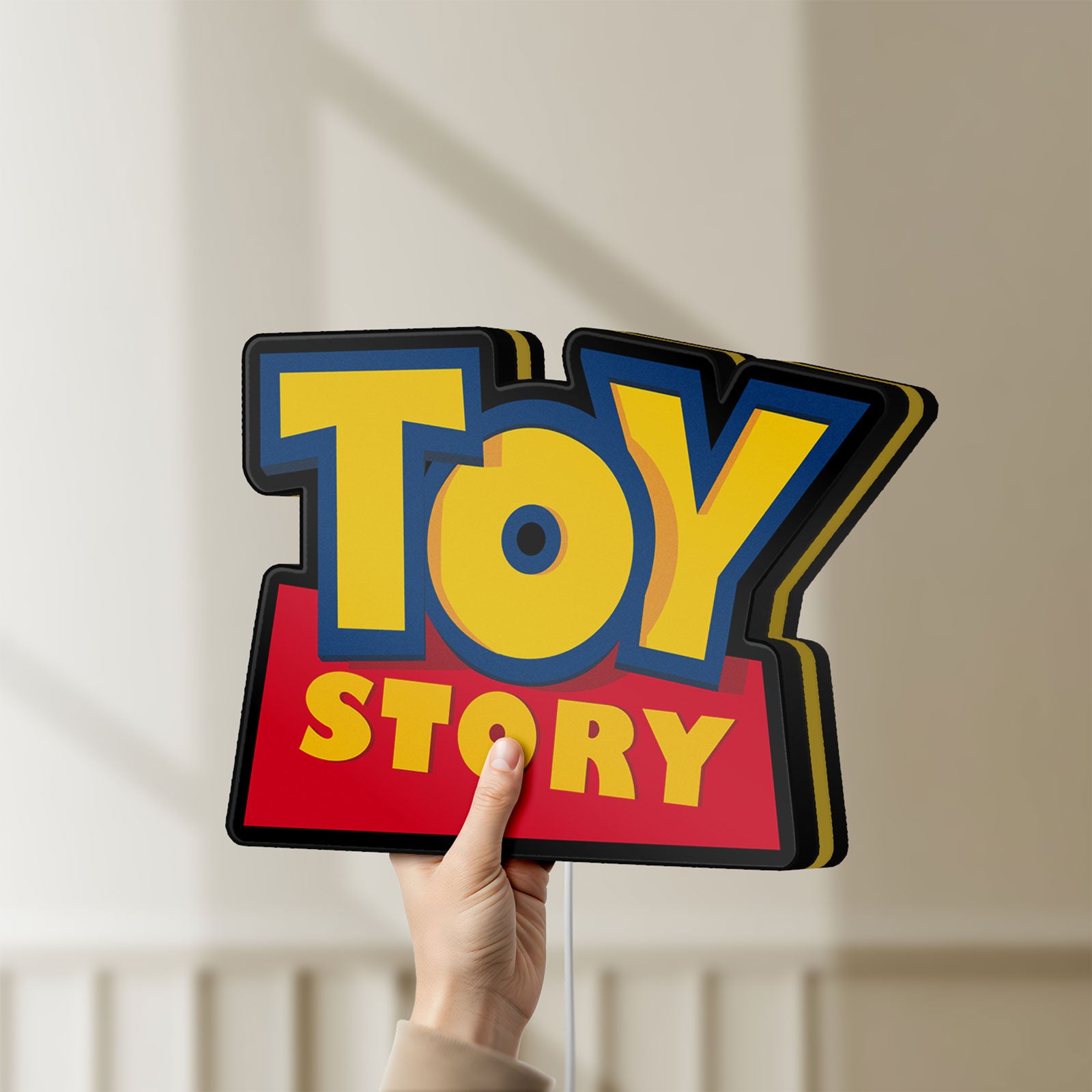 Unlit Toy Story LED lightbox held by hand to show size and details