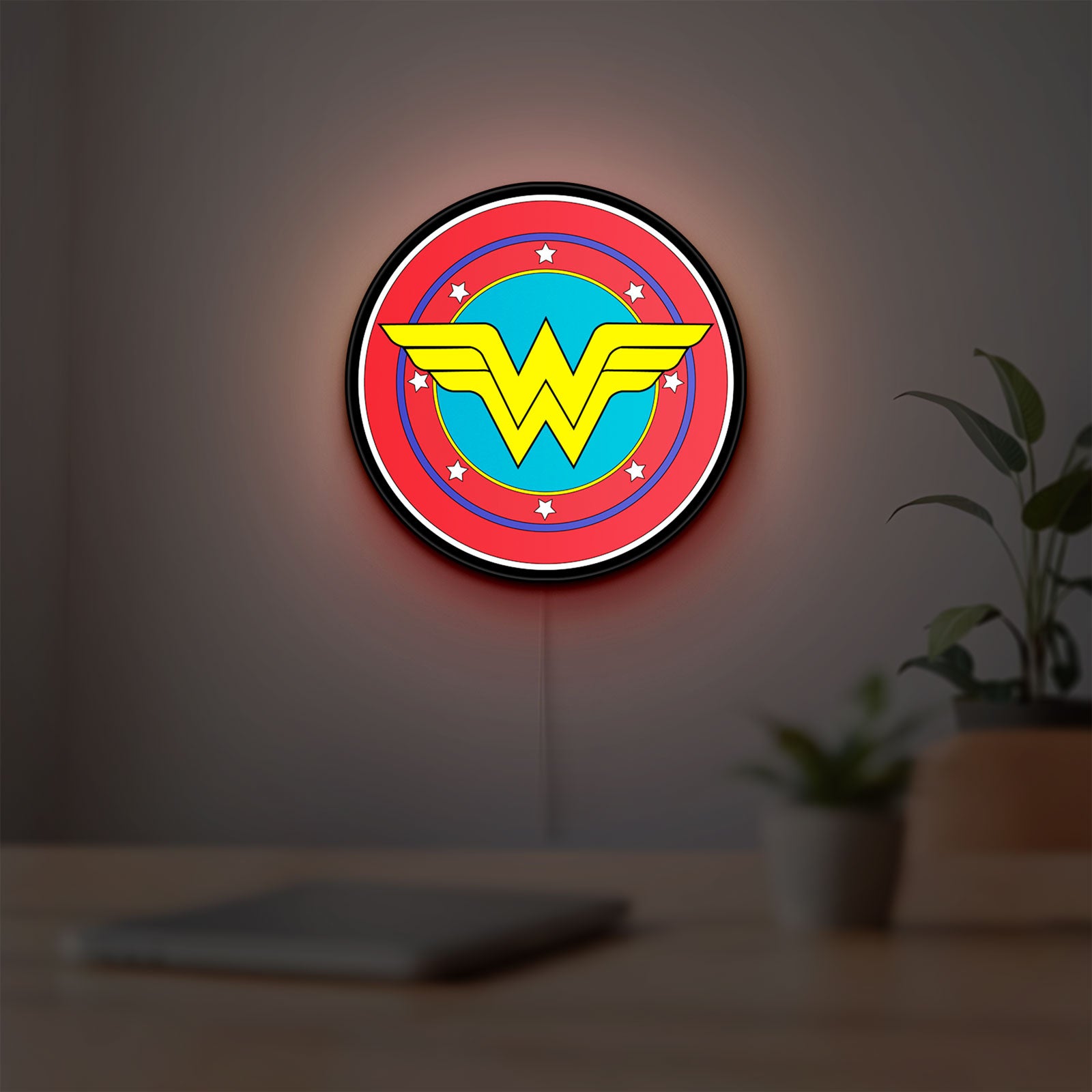 Wonder Woman LED lightbox hanging on a room wall with soft red light