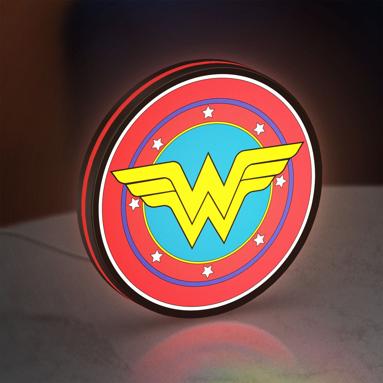 Wonder Woman LED lightbox standing on a desk from an angled side view with red glow