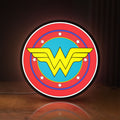 Front view of Wonder Woman LED lightbox sign glowing on a wooden desk