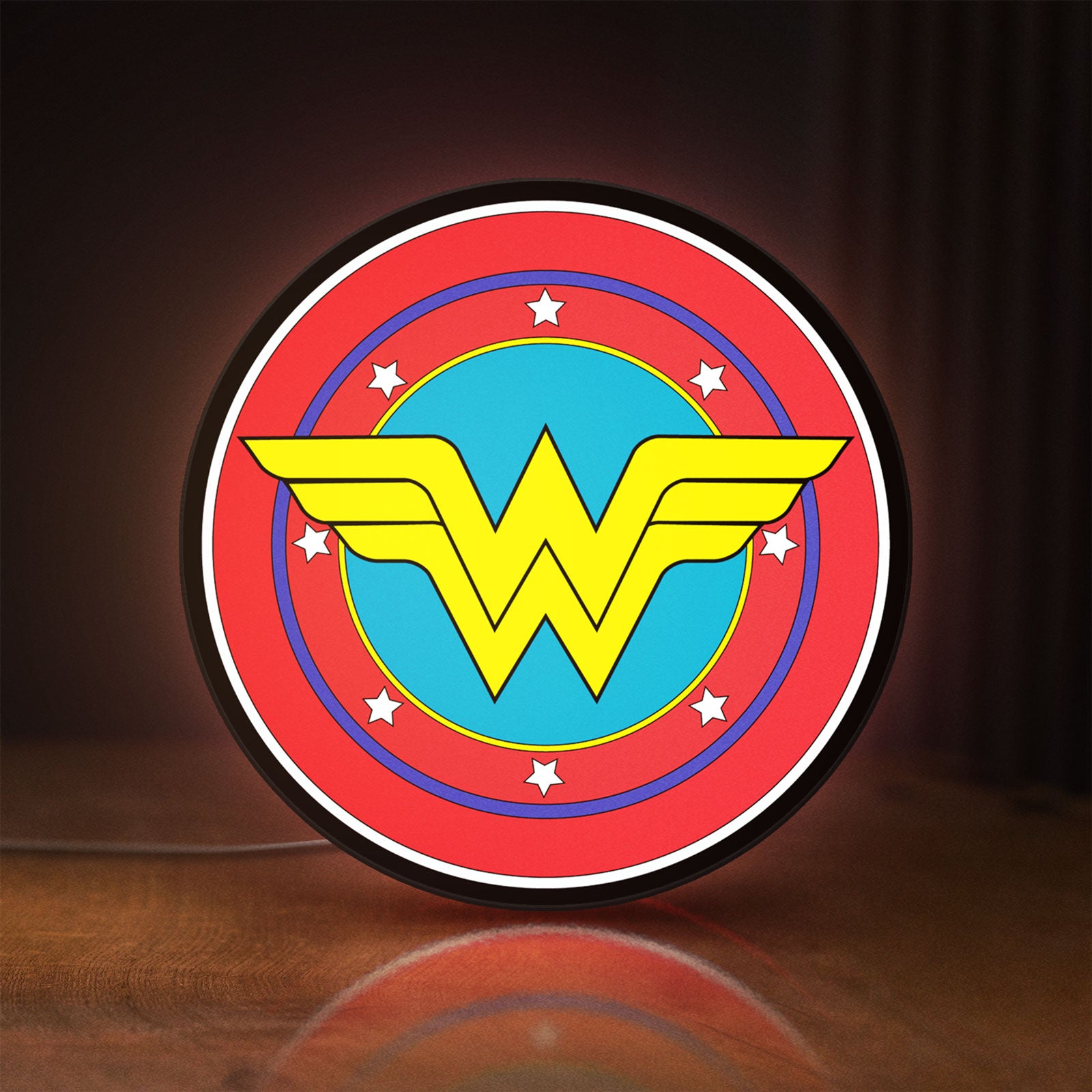 Front view of Wonder Woman LED lightbox sign glowing on a wooden desk