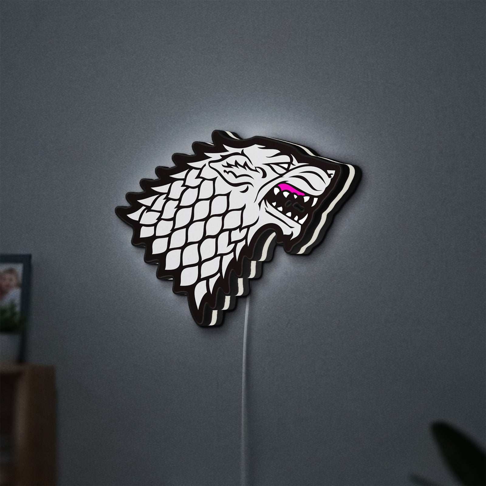 House Stark LED lightbox hanging on a wall with white glow