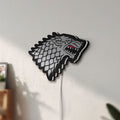 Unlit House Stark LED lightbox mounted on a wall in daylight