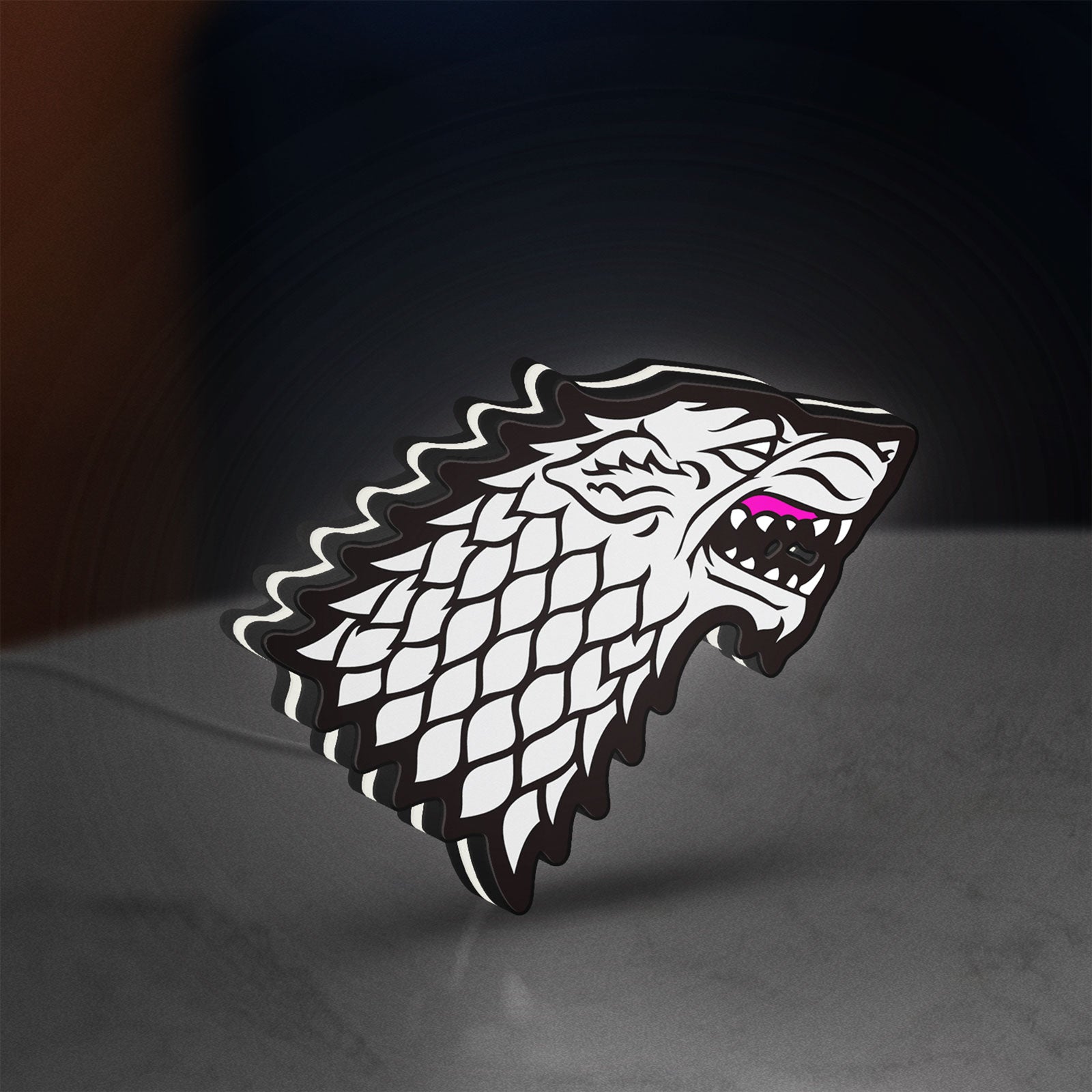 House Stark LED lightbox standing on a desk from an angled side view with white glow