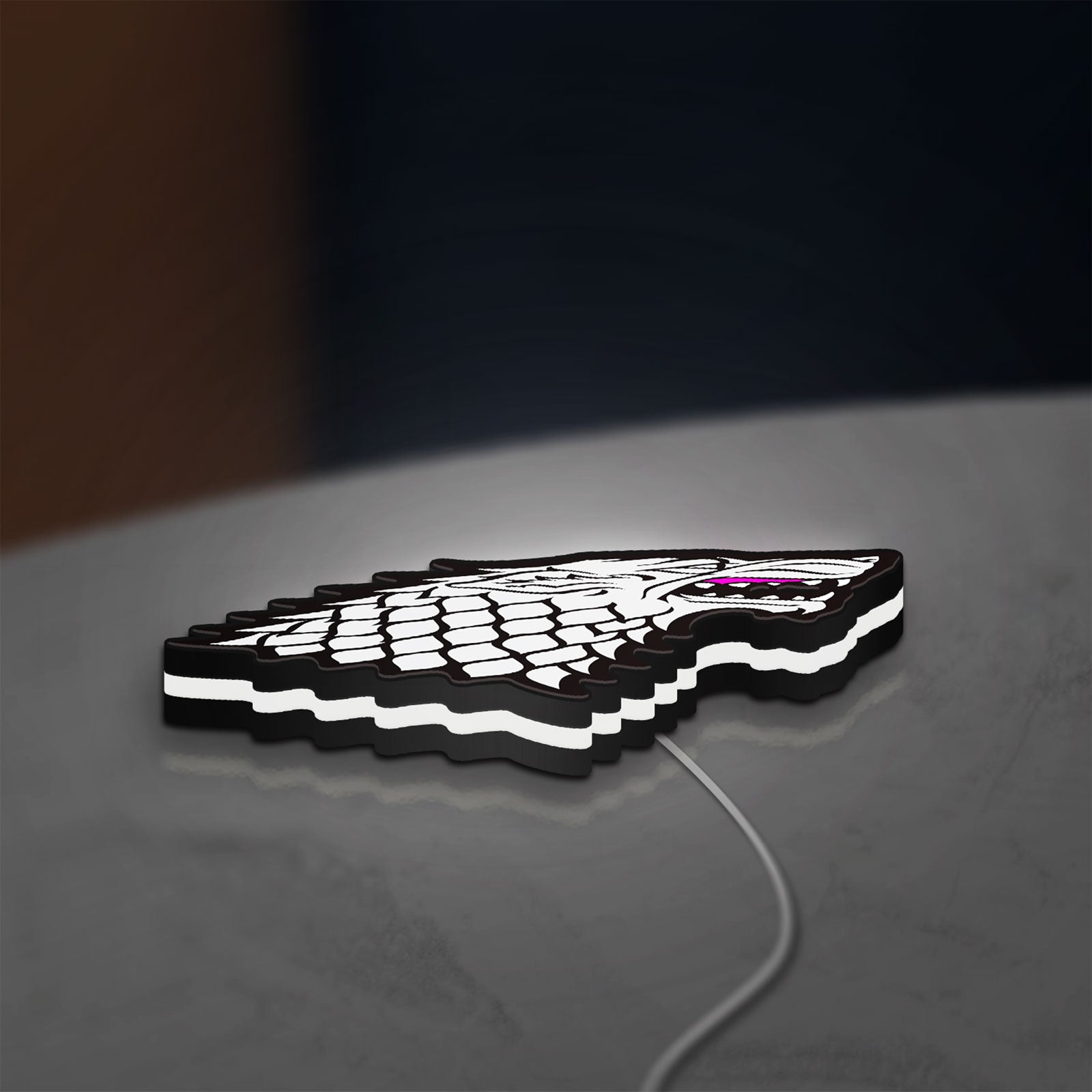 House Stark LED lightbox lying flat on a desk with white glow