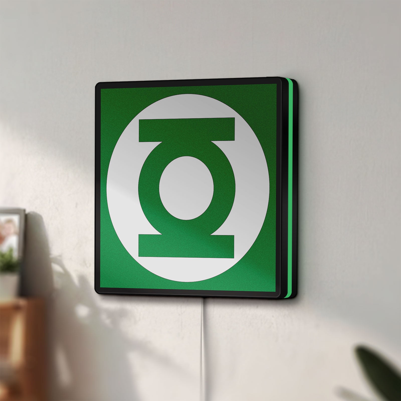 Unlit Green Lantern Corps LED lightbox mounted on a wall in daylight