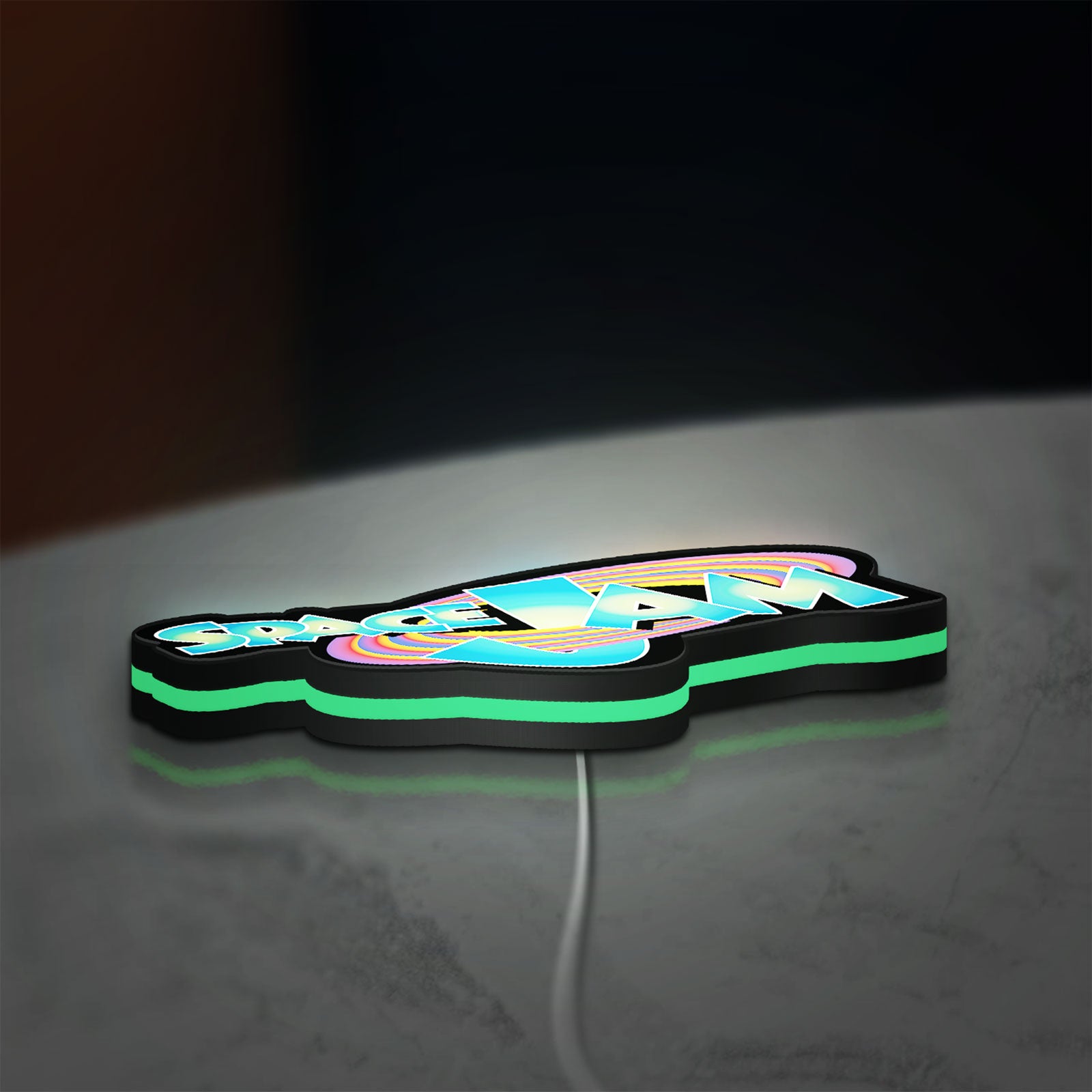 Space Jam LED lightbox lying flat on a desk with green glow