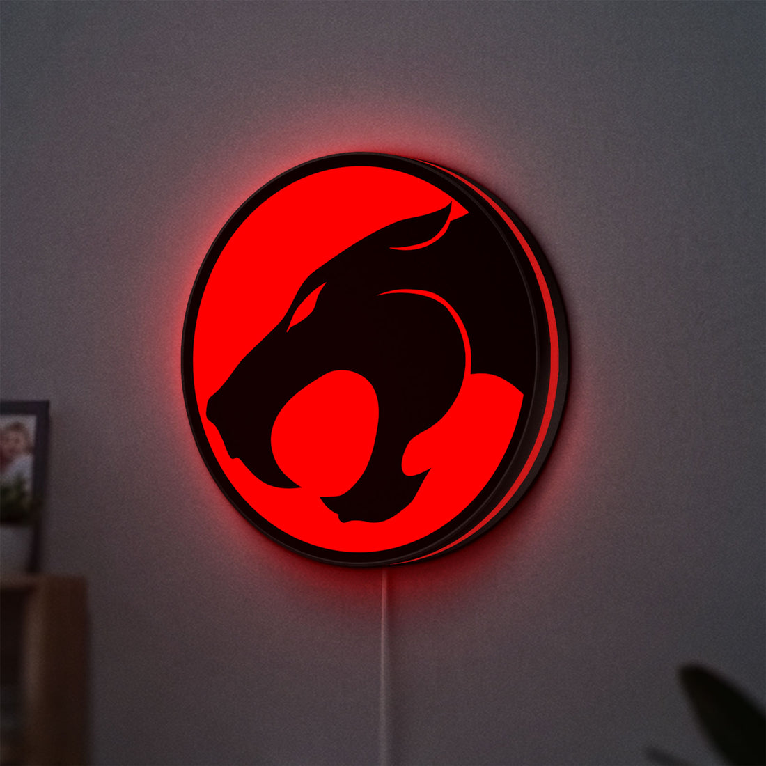 Thundercats 80s Retro LED lightbox hanging on a wall with red glow