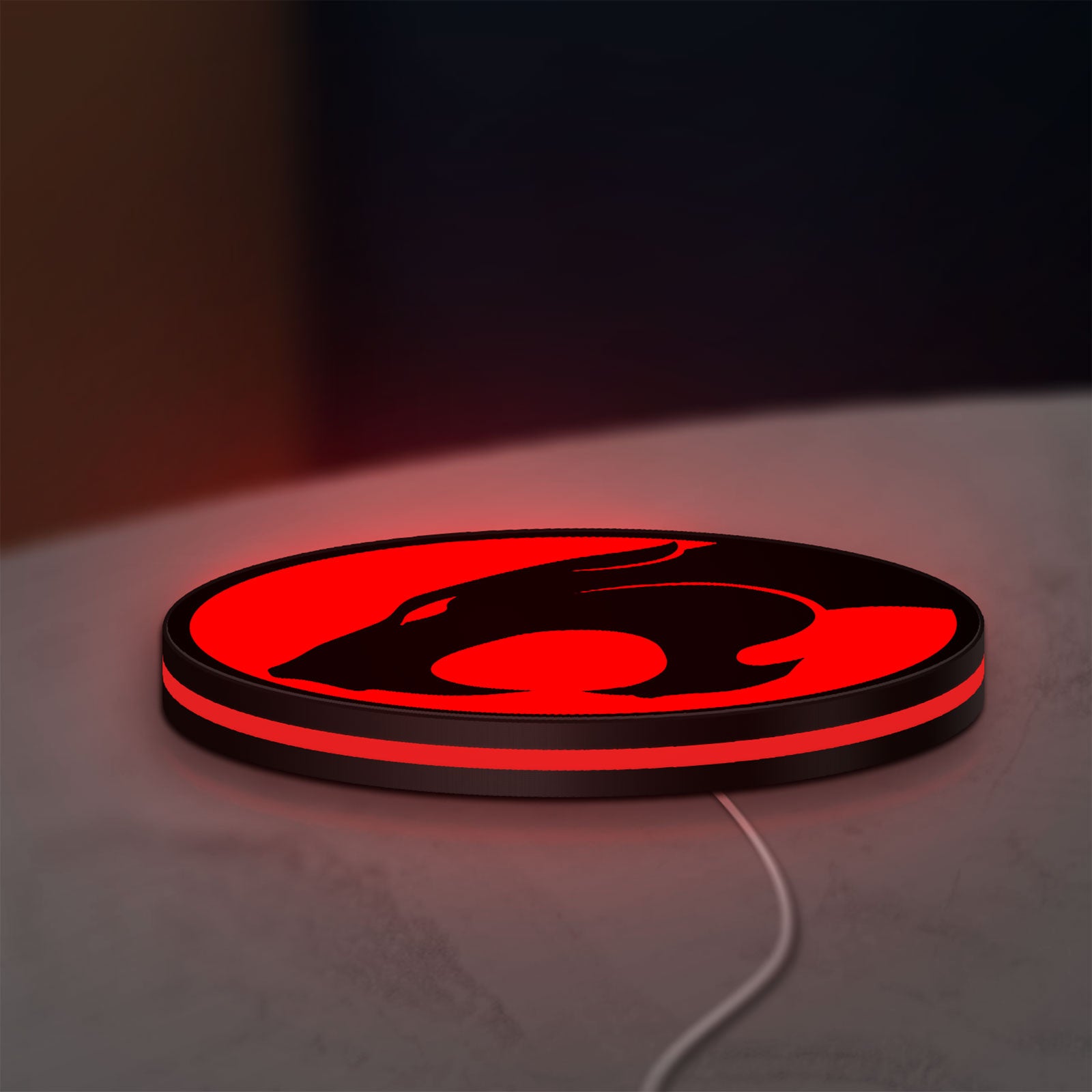Thundercats 80s Retro LED lightbox lying flat on a desk with red glow
