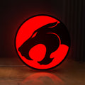 Front view of Thundercats 80s Retro LED lightbox sign glowing on a wooden desk