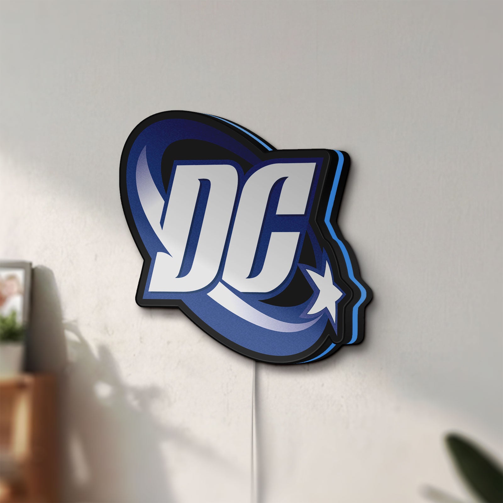 Unlit DC Comics LED lightbox mounted on a wall in daylight