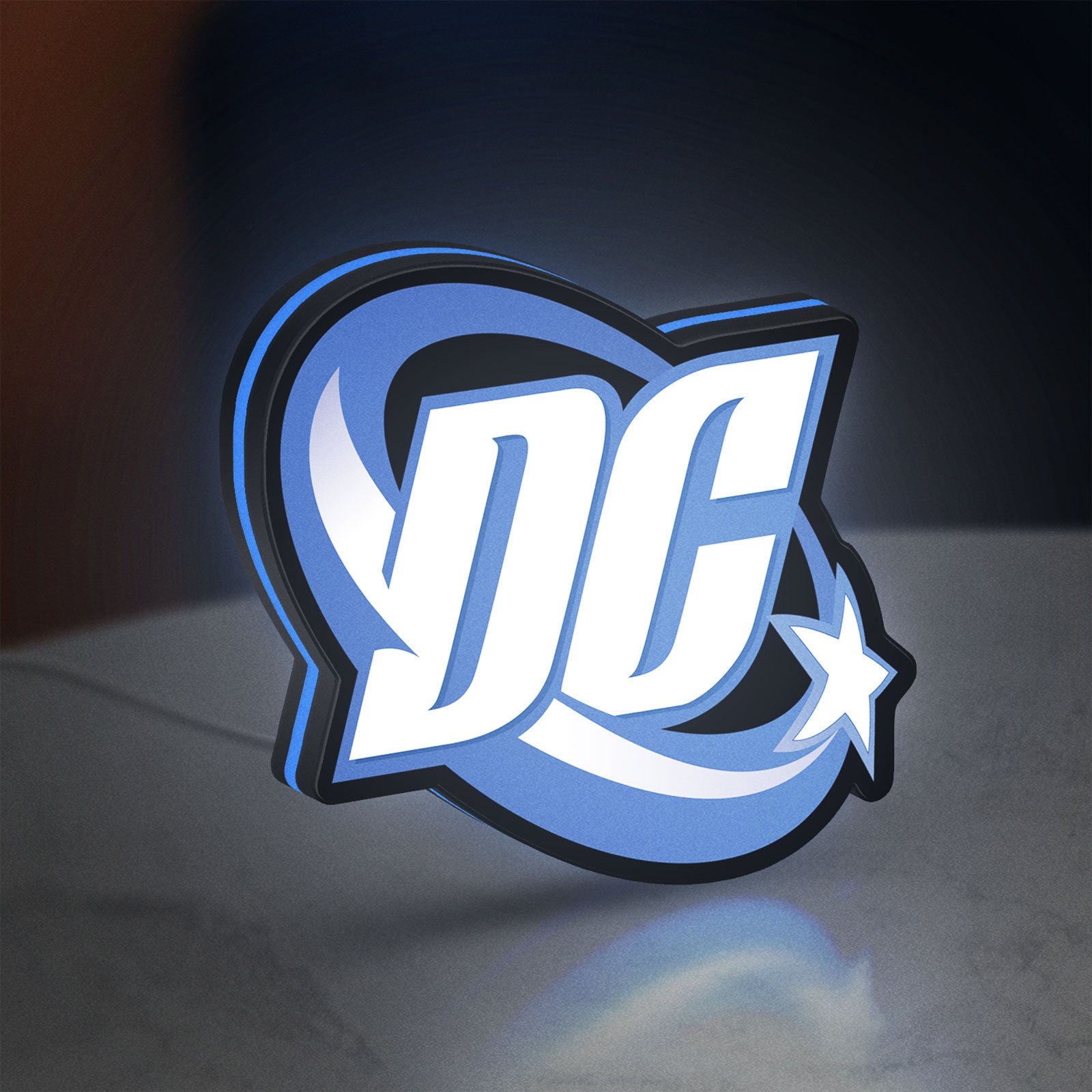 DC Comics LED lightbox standing on a desk from an angled side view with blue glow