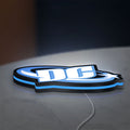 DC Comics LED lightbox lying flat on a desk with blue glow