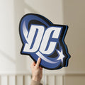 Unlit DC Comics LED lightbox held by hand to show size and details