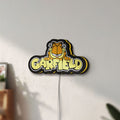Unlit Garfield LED lightbox mounted on a wall in daylight