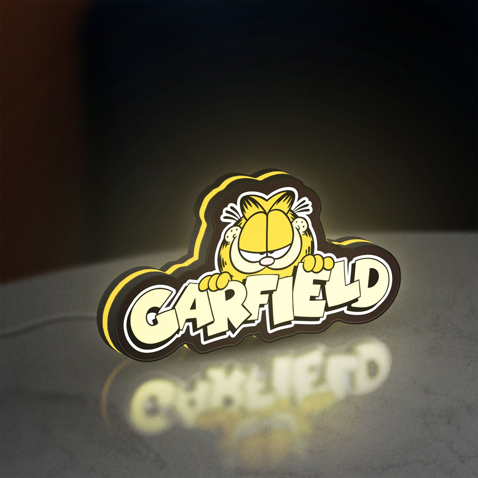 Garfield LED lightbox standing on a desk from an angled side view with yellow glow