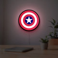 Captain America Shield LED lightbox hanging on a room wall with soft red light
