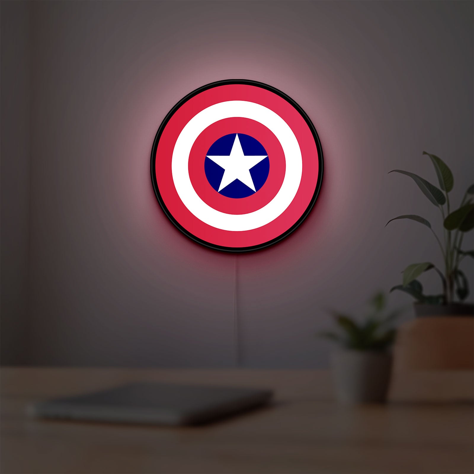 Captain America Shield LED lightbox hanging on a room wall with soft red light