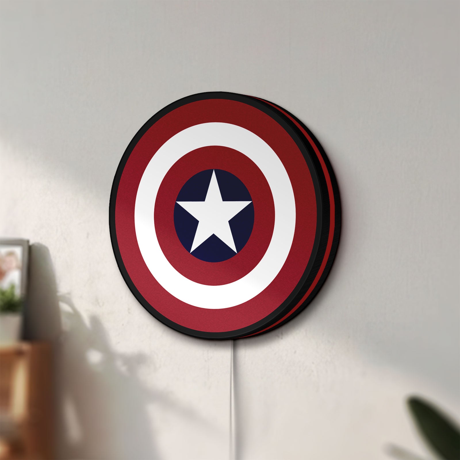 Unlit Captain America Shield LED lightbox mounted on a wall in daylight