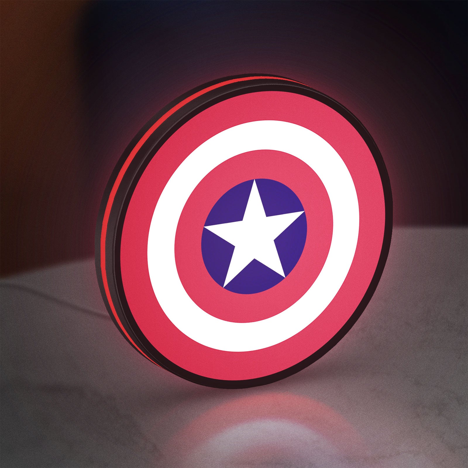 Captain America Shield LED lightbox standing on a desk from an angled side view with red glow