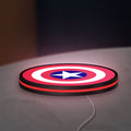 Captain America Shield LED lightbox lying flat on a desk with red glow