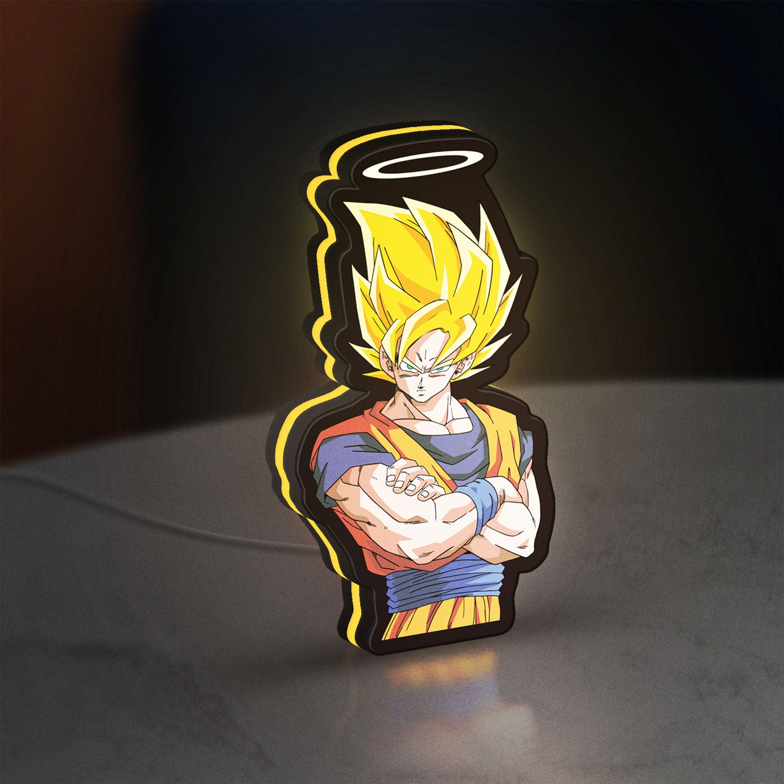 Dragon Ball Z Goku LED lightbox standing on a desk from an angled side view with yellow glow