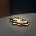 Dragon Ball Z Goku LED lightbox lying flat on a desk with yellow glow