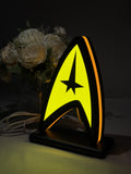 Illuminated angled view standing of Star Trek Command Insignia 3D LED Sign in 20cm, unique wall art for desk and room decor