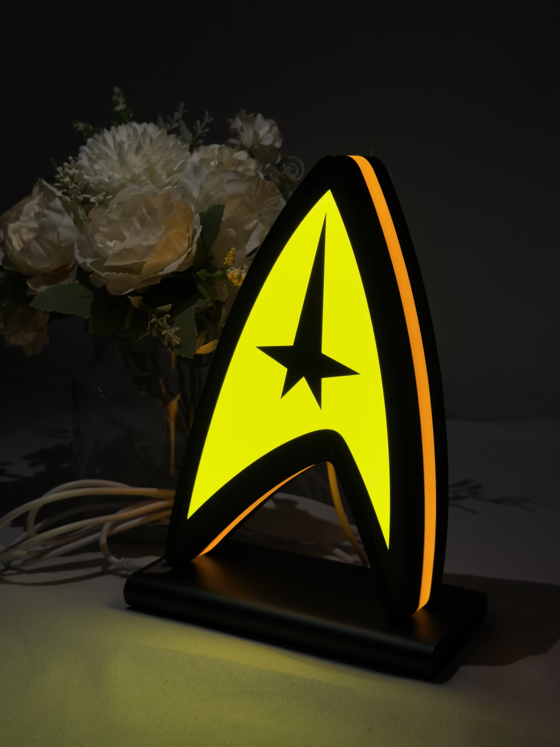 Illuminated angled view standing of Star Trek Command Insignia 3D LED Sign in 20cm, unique wall art for desk and room decor