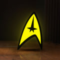 Front view of Star Trek Command Insignia LED lightbox sign glowing on a wooden desk