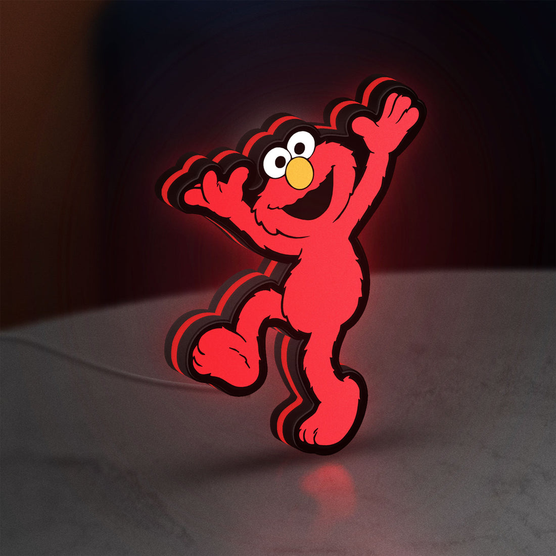 Elmo LED LED lightbox hanging on a wall with red glow