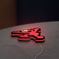 Elmo LED LED lightbox lying flat on a desk with red glow
