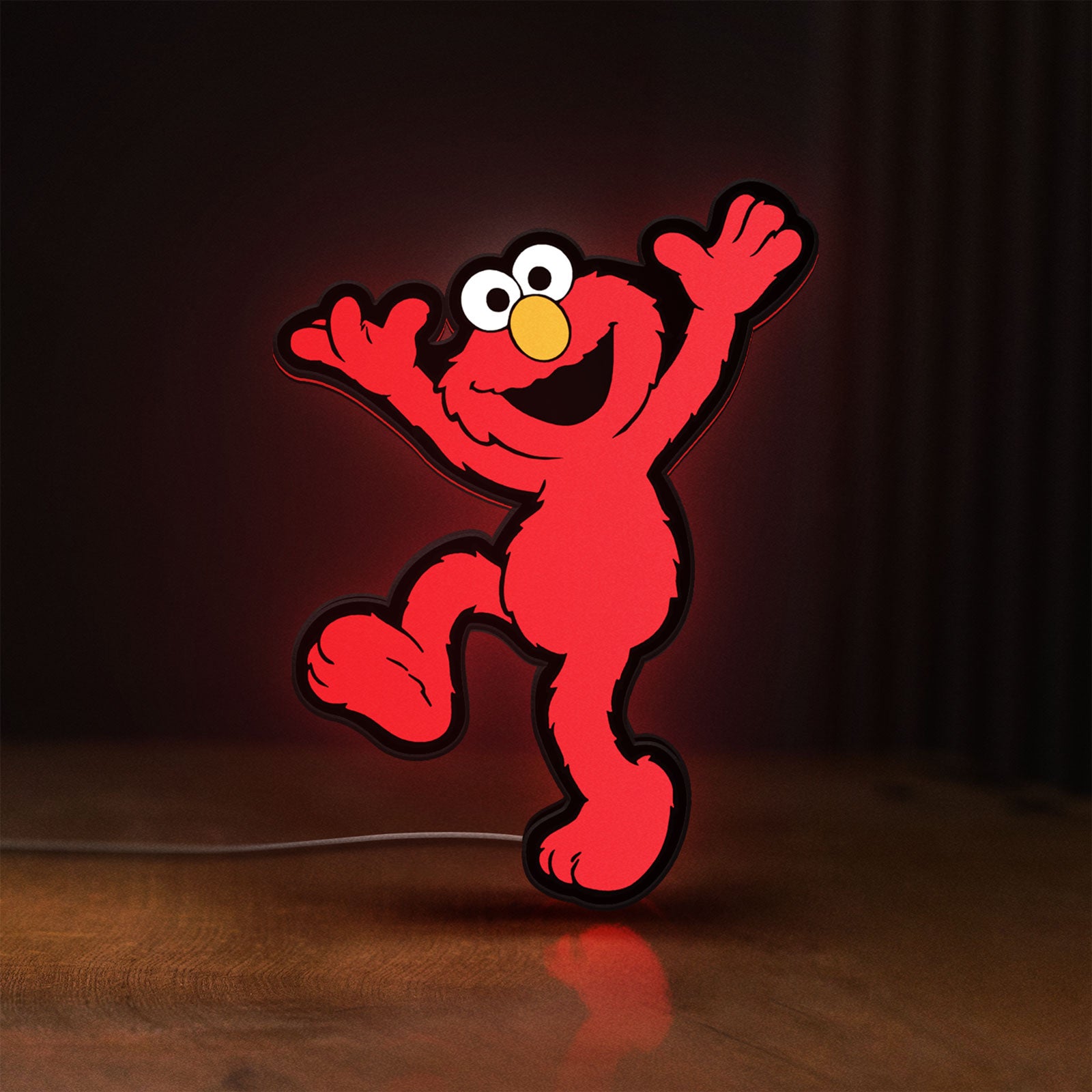 Front view of Elmo LED LED lightbox sign glowing on a wooden desk