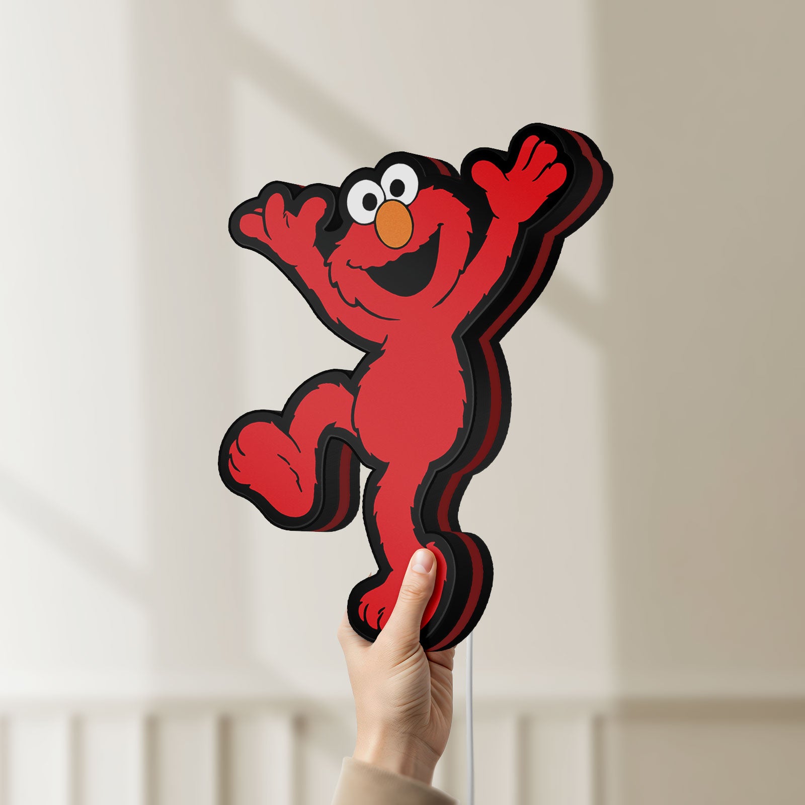 Unlit Elmo LED LED lightbox held by hand to show size and details